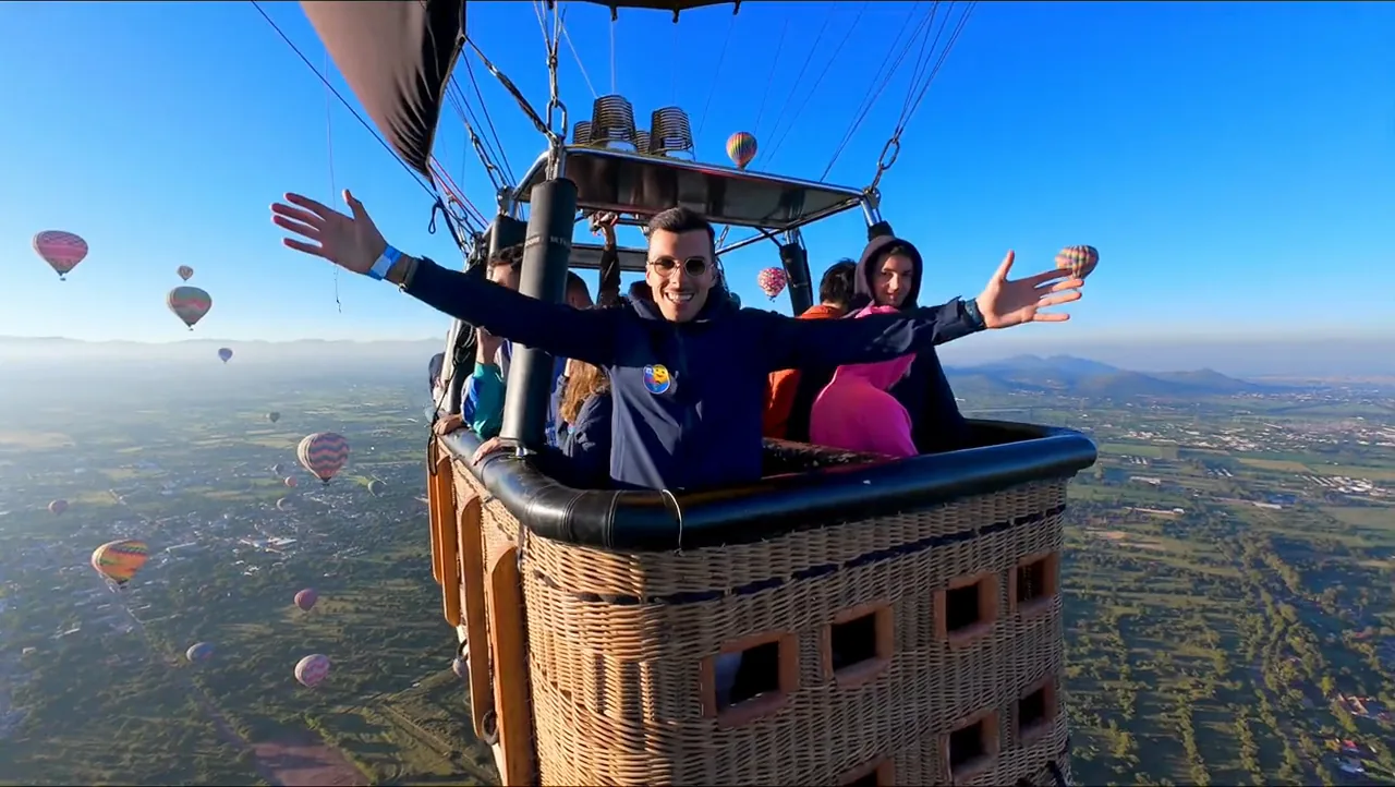 Pasajero con brazos abiertos en la canastilla sobre el valle de Teotihuacán, vuelo con transporte desde CDMX